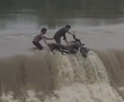 Courting Danger: Two youths swept away along with their bike in the swollen Lilagar River; locals saved their lives